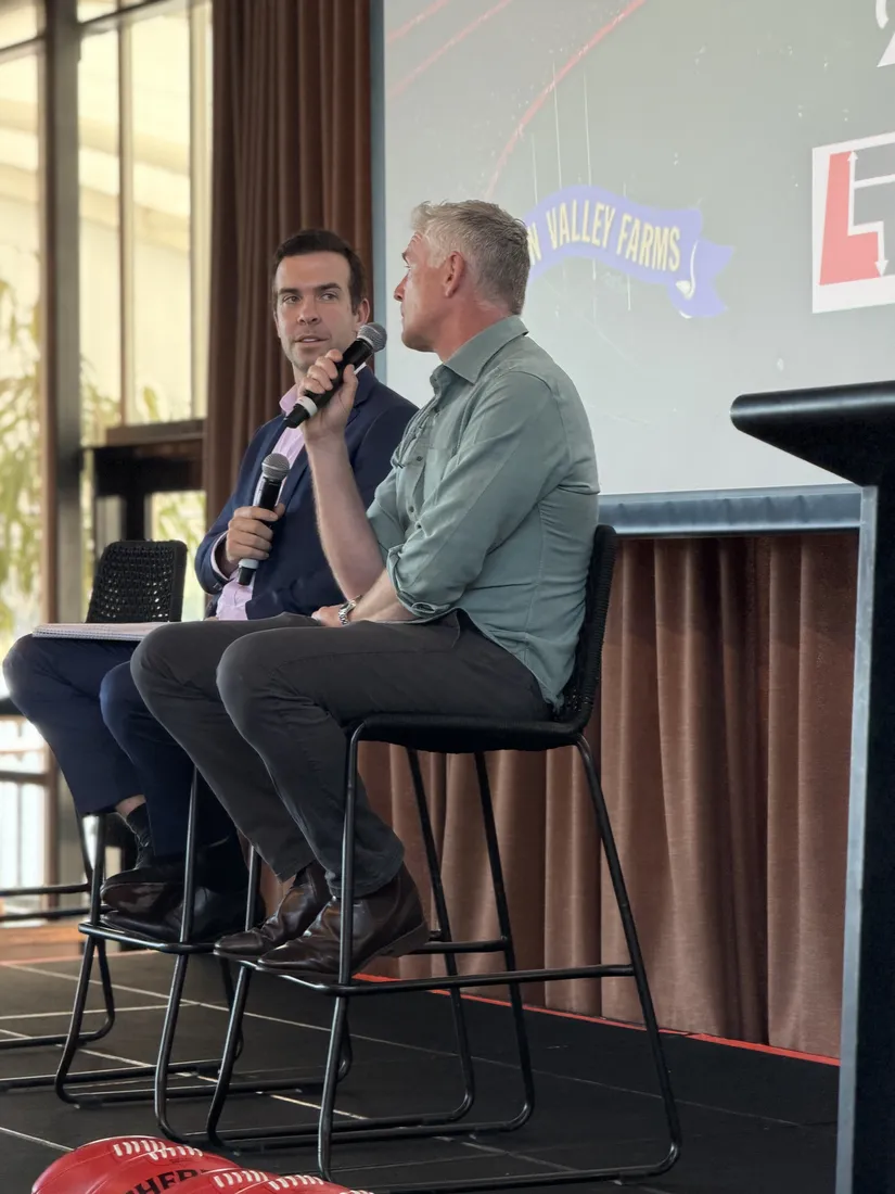 Speakers in conversation on stage