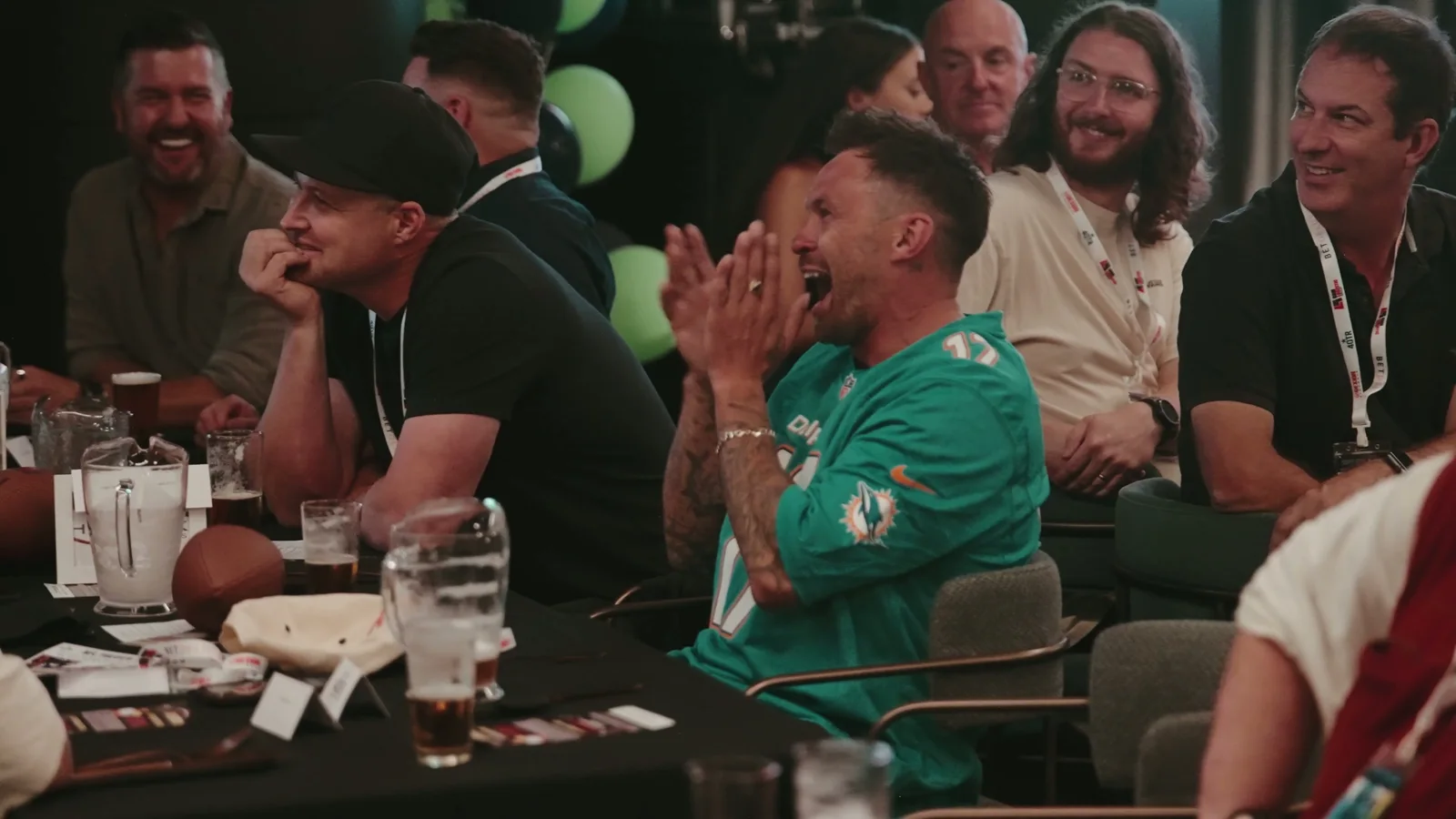 Guests laughing together in the 4QTR promotional film