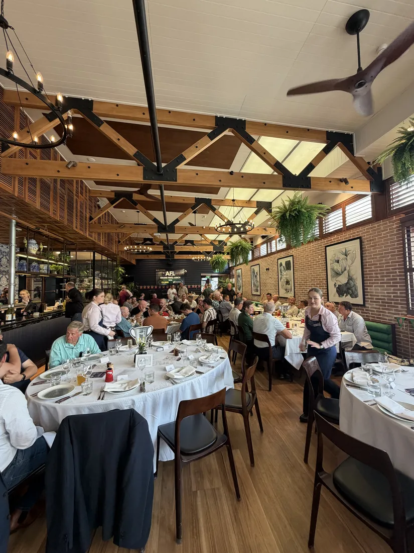 Guests gathered around tables at the Brisbane event
